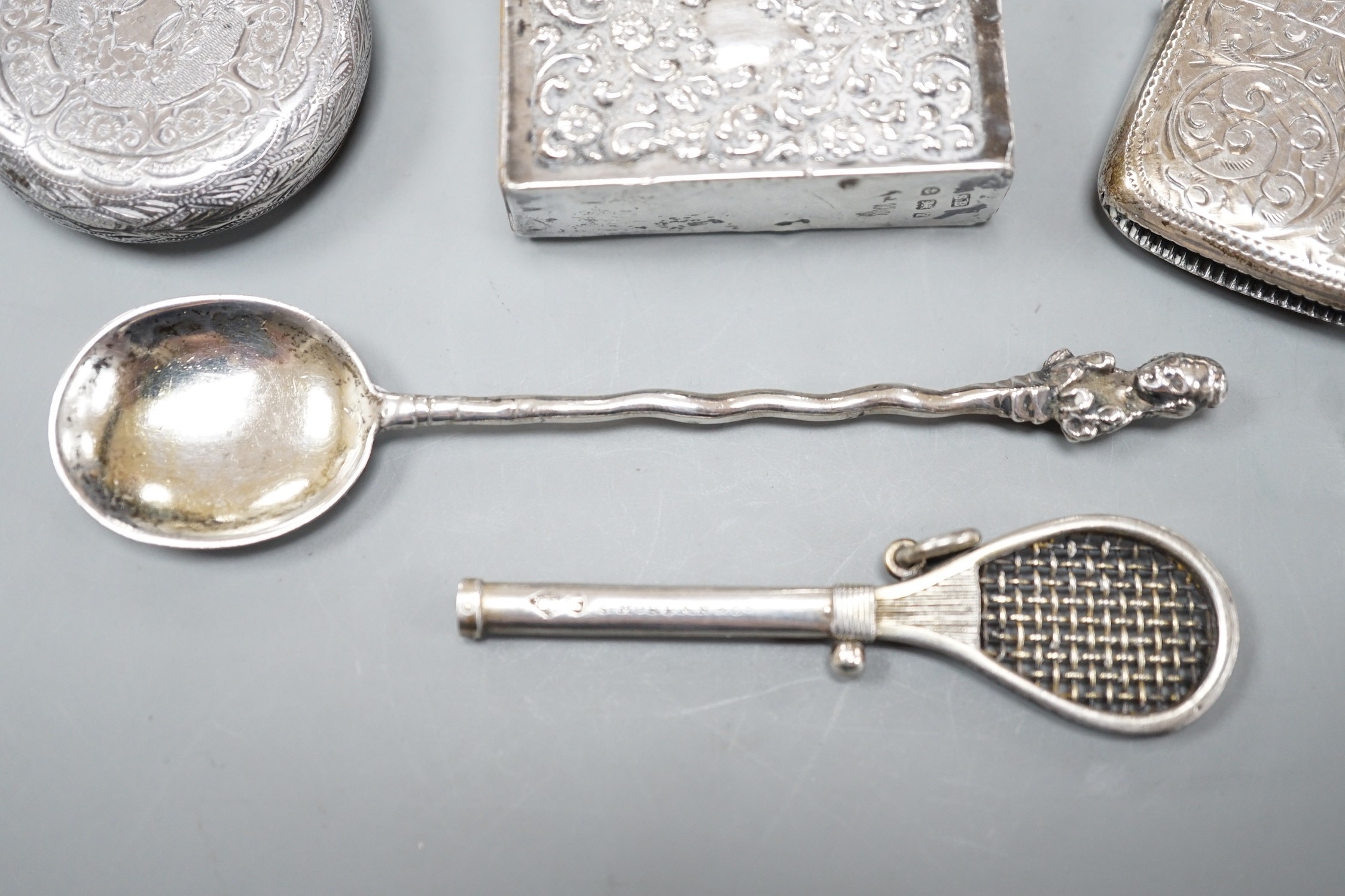 A late Victorian novelty white metal propelling pencil, modelled as a tennis racket, by Sampson Mordan & Co, 64mm, together with a watch case, silver vesta case, spoon and silver matchbox sleeve.